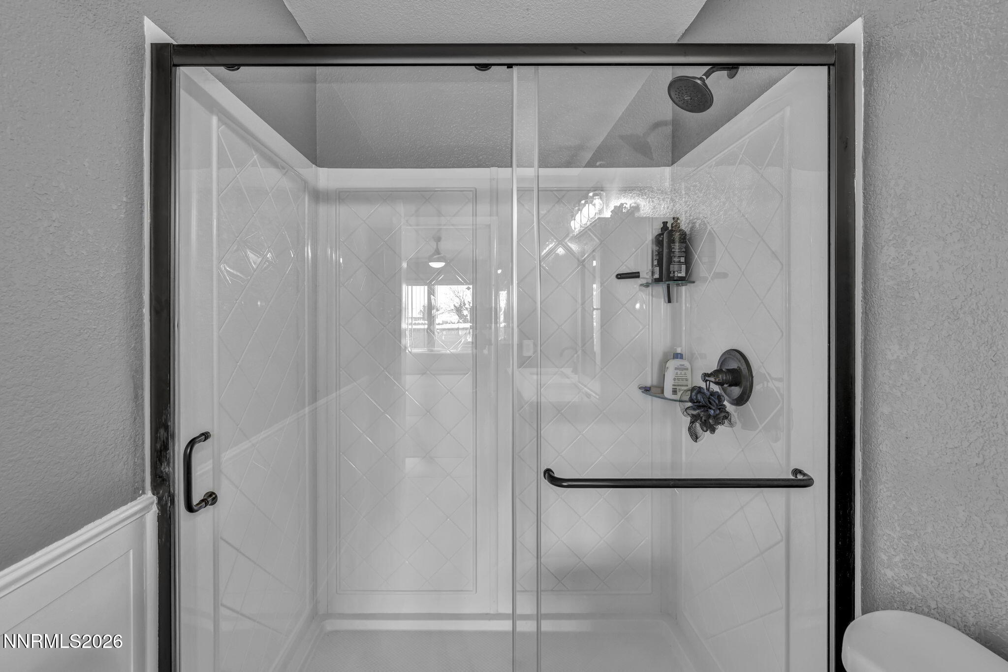 18270 Cedar View Court Reno, NV 89508 - Photo 20 of 48 a bathroom with a glass shower door and a mirror