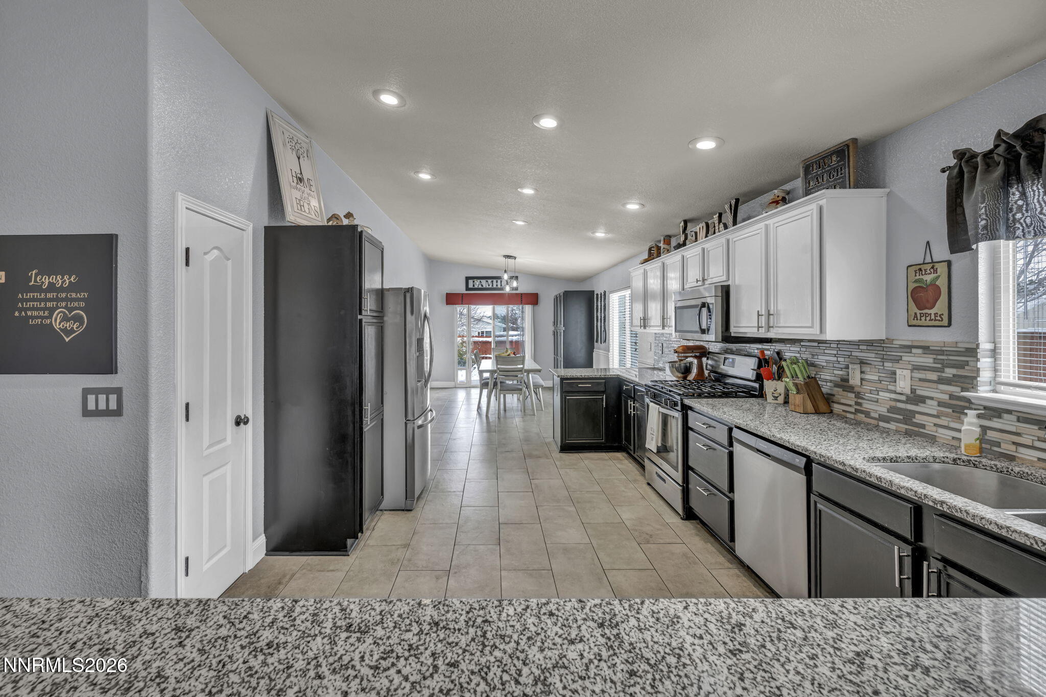 18270 Cedar View Court Reno, NV 89508 - Photo 5 of 48 a large kitchen with stainless steel appliances kitchen island granite countertop a refrigerator and a sink