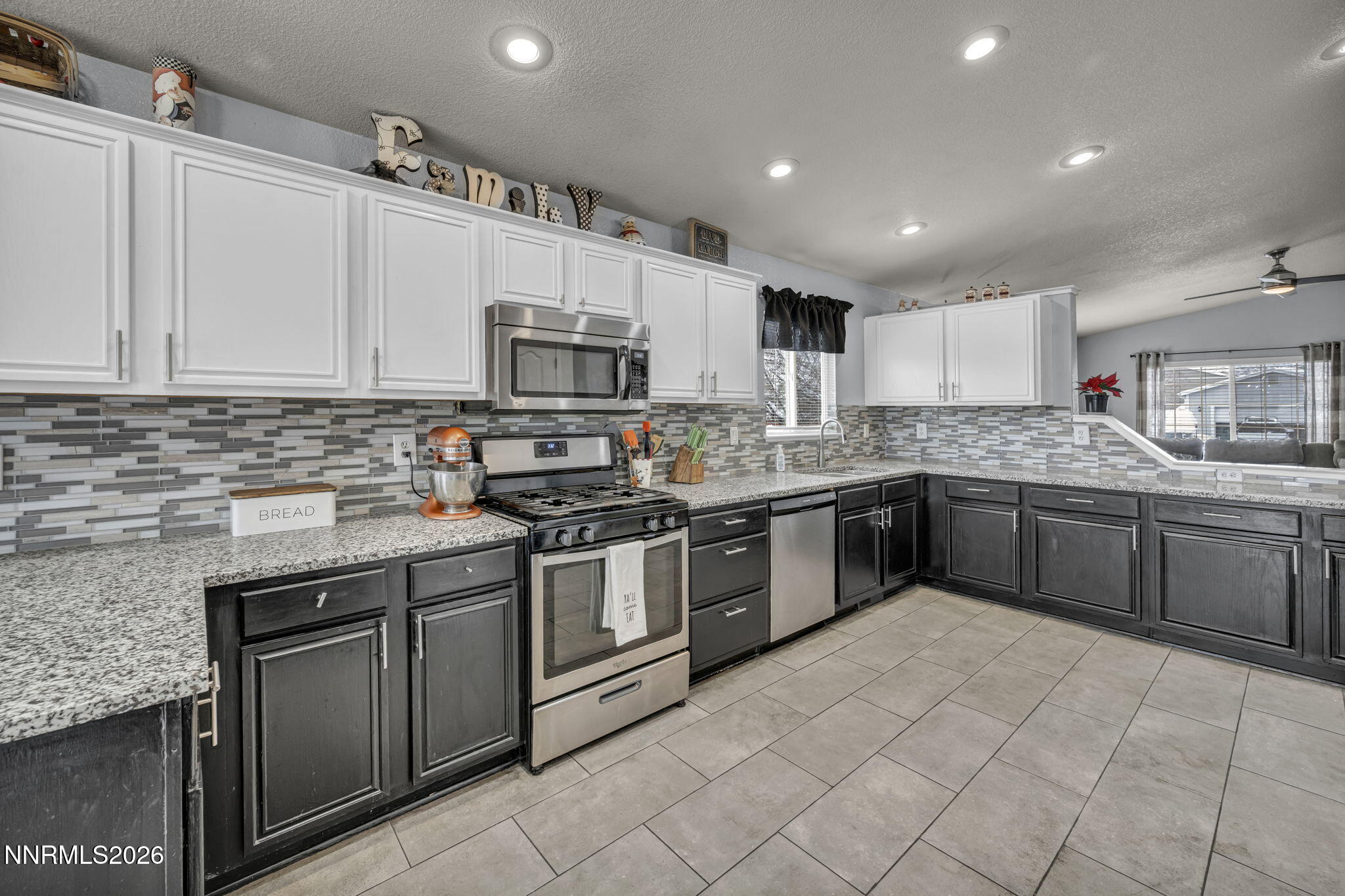 18270 Cedar View Court Reno, NV 89508 - Photo 7 of 48 a kitchen with stainless steel appliances granite countertop a sink counter space cabinets and a large window