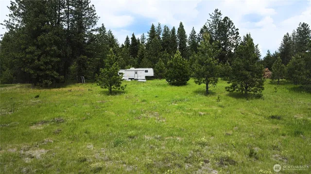 a backyard of a house with a yard and trampoline