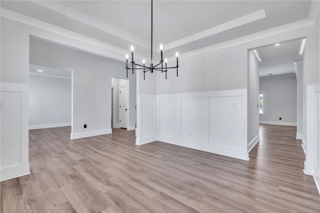 226 Holly Br Road Piedmont, SC 29673 - Photo 14 of 44 Elegant tray ceilings and warm wood flooring define this inviting, naturally lit dining space.