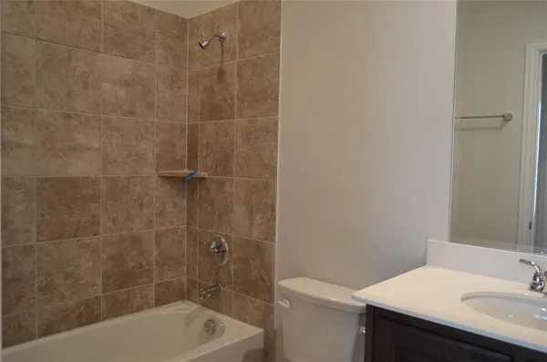 a bath tub sitting next to a white sink