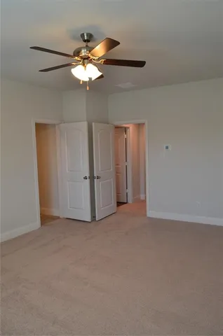 a view of a livingroom with a chandelier fan