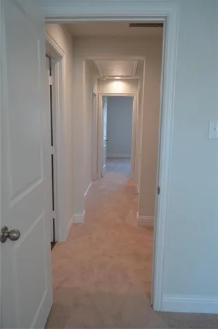 a view of a hallway to rooms