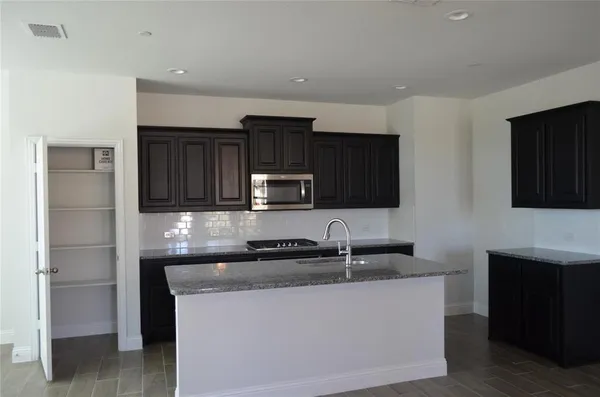 a kitchen with a sink and a refrigerator