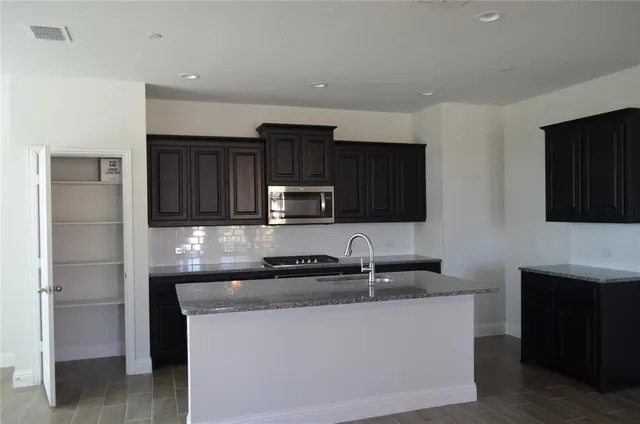 a kitchen with a sink and a refrigerator