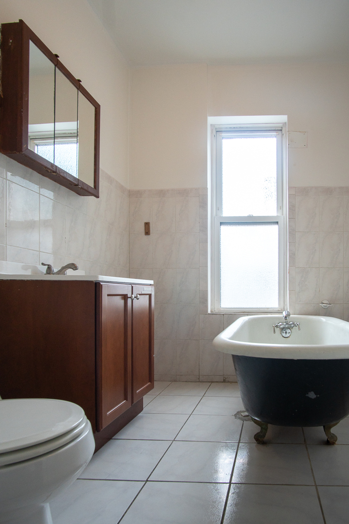 2519 North Pulaski Road Chicago, IL 60639 - Photo 11 of 36 a bathroom with a sink toilet and mirror