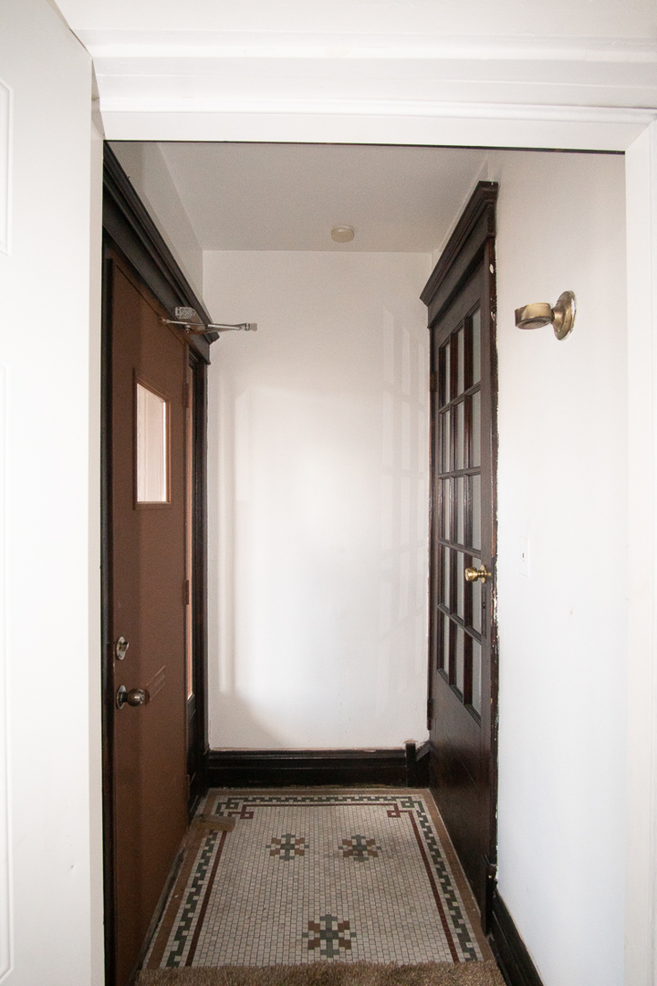 2519 North Pulaski Road Chicago, IL 60639 - Photo 13 of 36 a view of a hallway with wooden floor and a living room