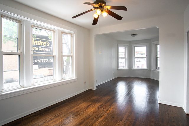2519 North Pulaski Road Chicago, IL 60639 - Photo 19 of 36 a view of an empty room with wooden floor and a window