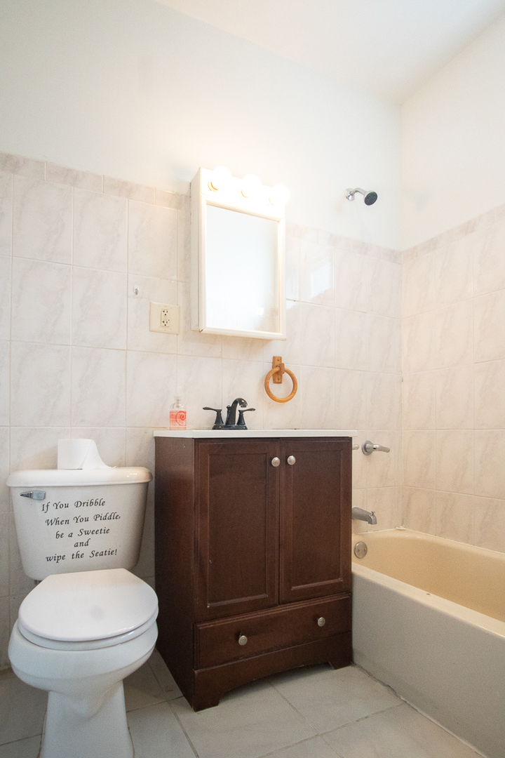 2519 North Pulaski Road Chicago, IL 60639 - Photo 20 of 36 a bathroom with a toilet a sink and bathtub