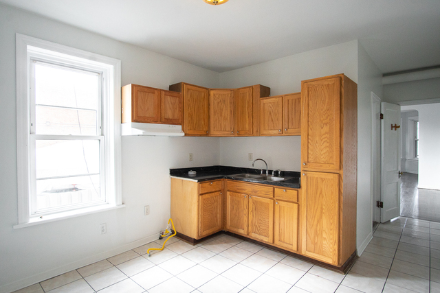 2519 North Pulaski Road Chicago, IL 60639 - Photo 23 of 36 a kitchen with stainless steel appliances granite countertop a refrigerator and a sink