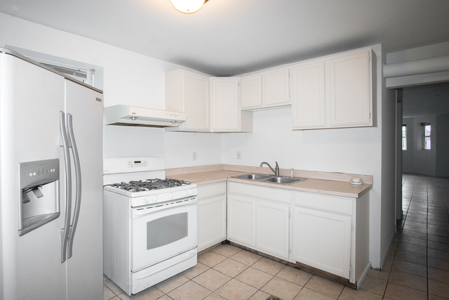 2519 North Pulaski Road Chicago, IL 60639 - Photo 24 of 36 a kitchen with white cabinets and white appliances