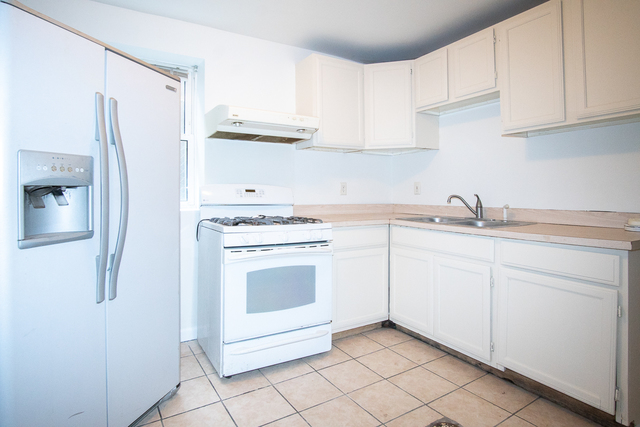 2519 North Pulaski Road Chicago, IL 60639 - Photo 27 of 36 a kitchen with white cabinets and white appliances