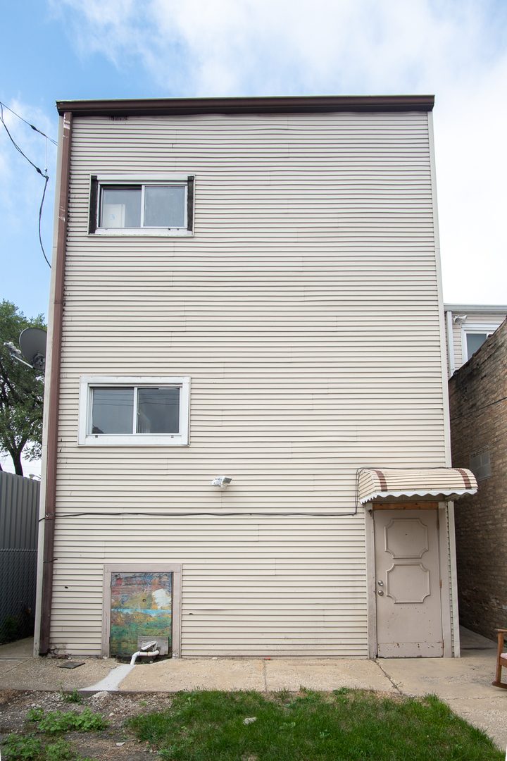 2519 North Pulaski Road Chicago, IL 60639 - Photo 35 of 36 a front view of a house with a yard and garage