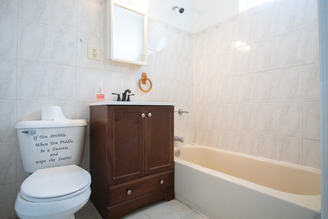 2519 North Pulaski Road Chicago, IL 60639 - Photo 7 of 36 a bathroom with a sink a toilet and bathtub