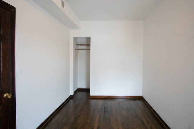2519 North Pulaski Road Chicago, IL 60639 - Photo 9 of 36 a view of an empty room with wooden floor