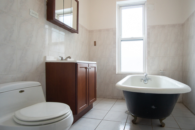 2519 North Pulaski Road Chicago, IL 60639 - Photo 10 of 36 a bathroom with a sink toilet and mirror