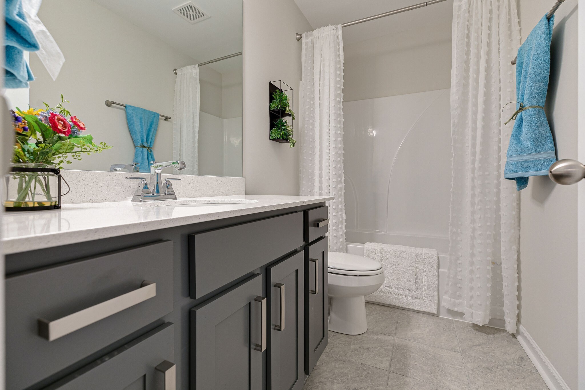 1054 June Wilde Ridge Spring Hill, TN 37174 - Photo 25 of 28 a bathroom with a sink a toilet and shower curtain