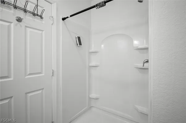 a bathroom with a glass shower door