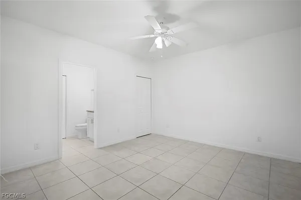 an empty room with kitchen view