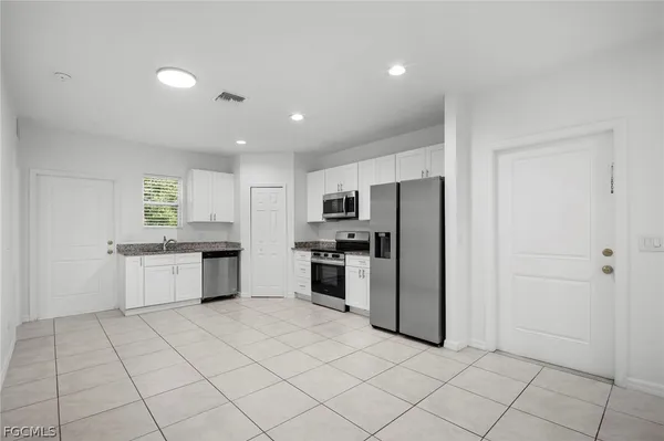 a kitchen with stainless steel appliances a refrigerator sink and stove