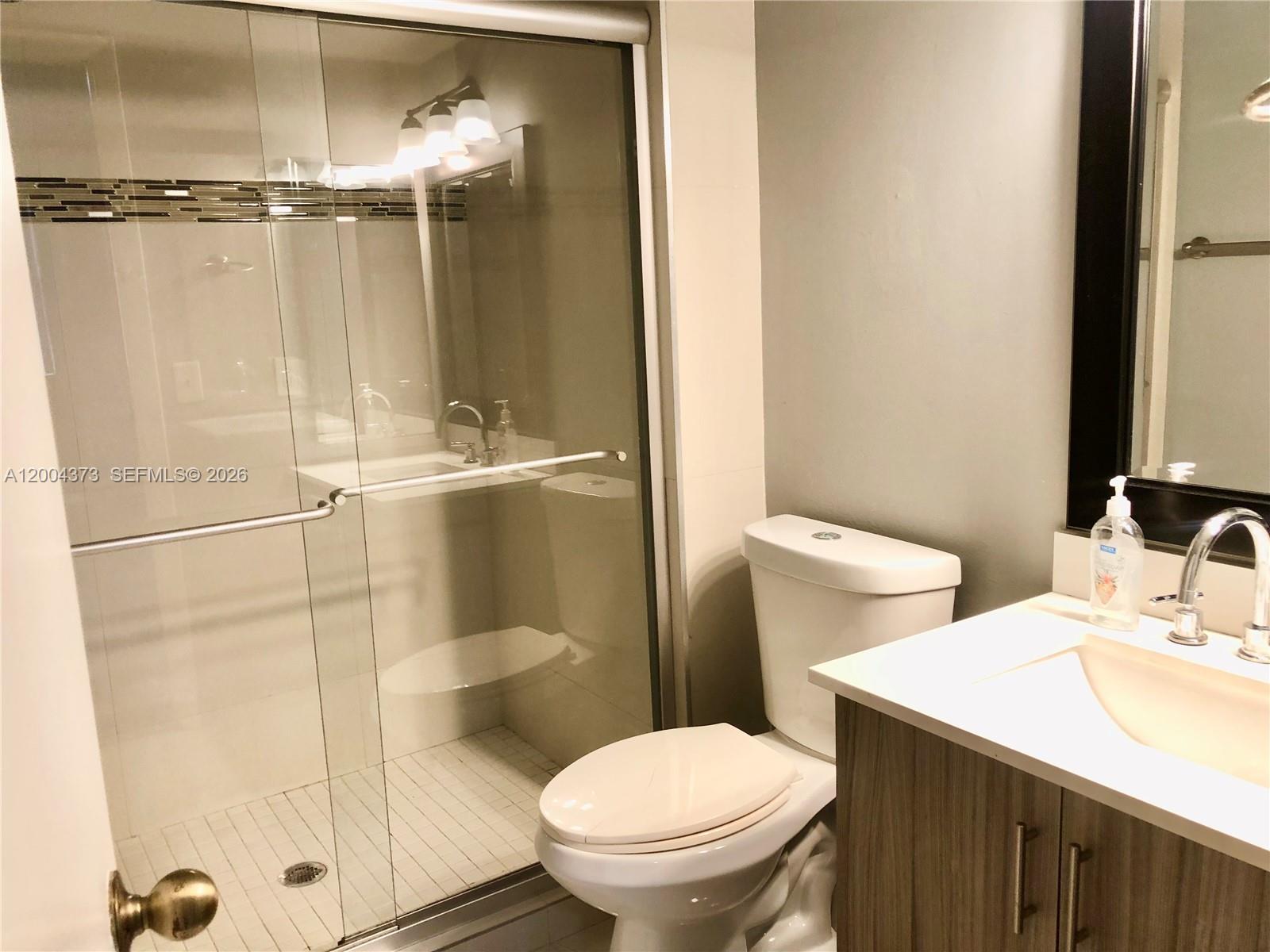 8761 Wiles Road, Unit 306 Coral Springs, FL 33067 - Photo 19 of 19 a bathroom with a sink toilet and shower