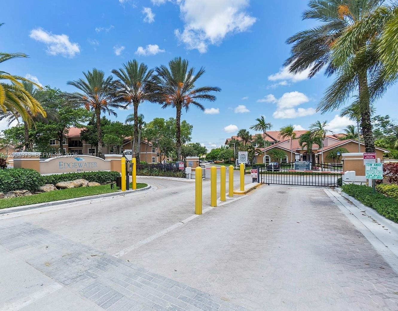 8761 Wiles Road, Unit 306 Coral Springs, FL 33067 - Photo 2 of 19 a view of outdoor space with palm trees