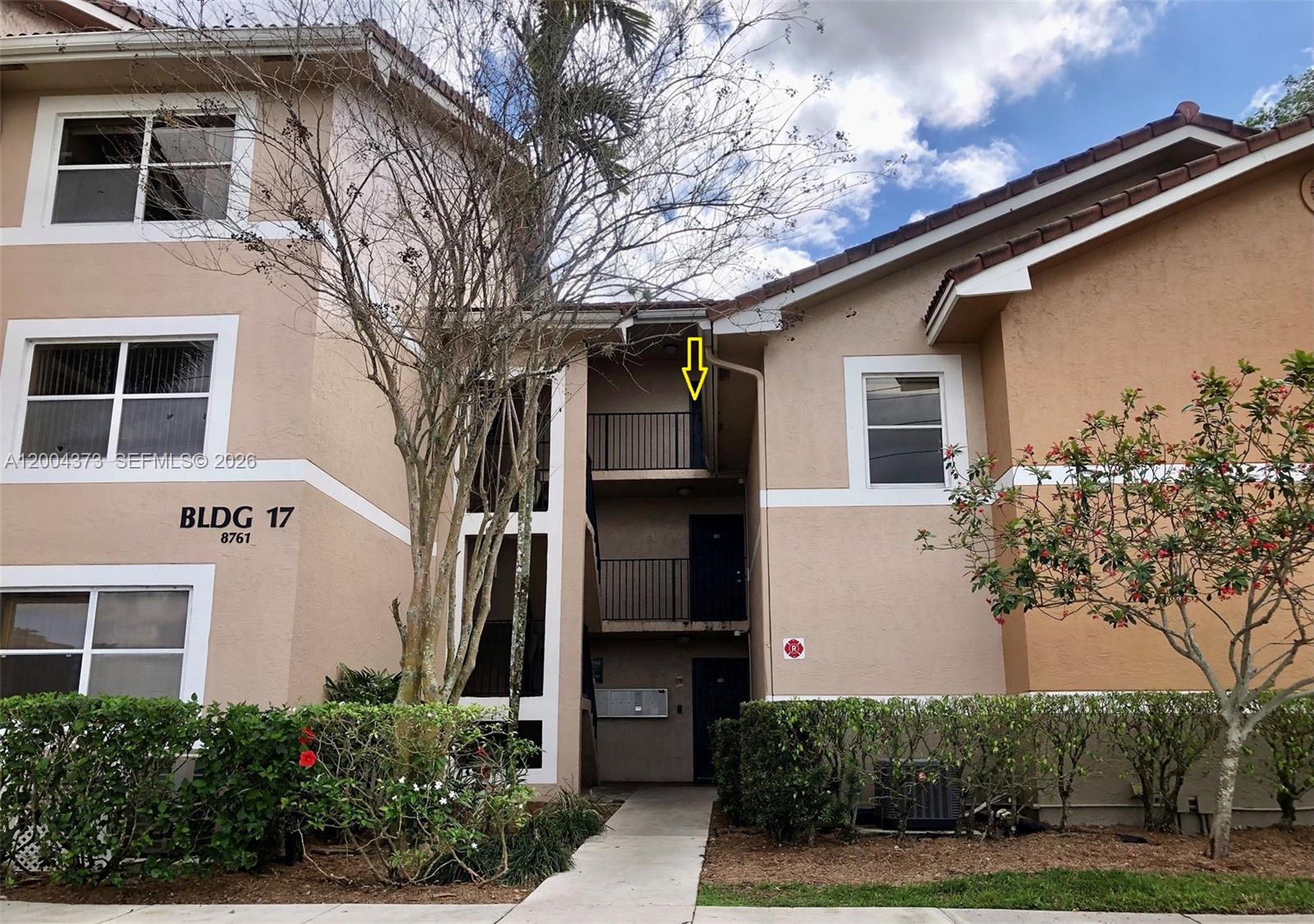 8761 Wiles Road, Unit 306 Coral Springs, FL 33067 - Photo 3 of 19 a house that has a tree in front of the house