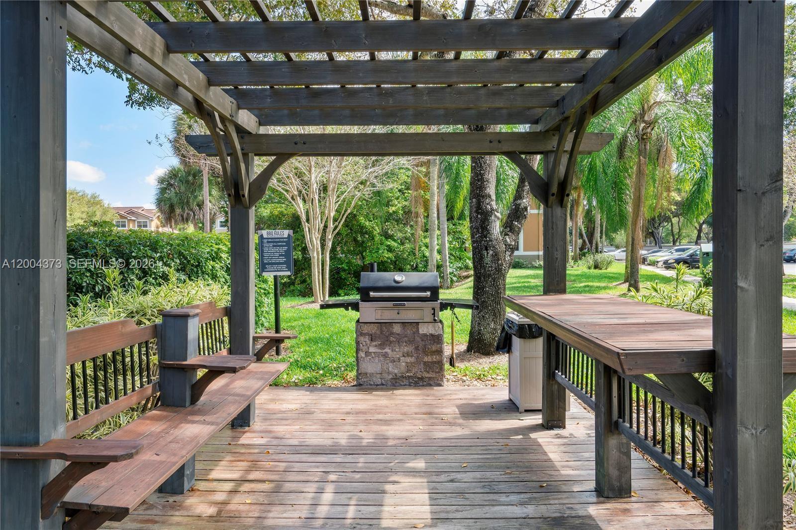 8761 Wiles Road, Unit 306 Coral Springs, FL 33067 - Photo 5 of 19 a backyard of a house with garden view and outdoor seating