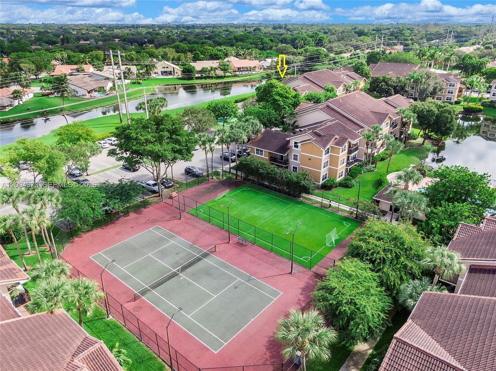 8761 Wiles Road, Unit 306 Coral Springs, FL 33067 - Photo 7 of 19 an aerial view of a house with a garden and lake view