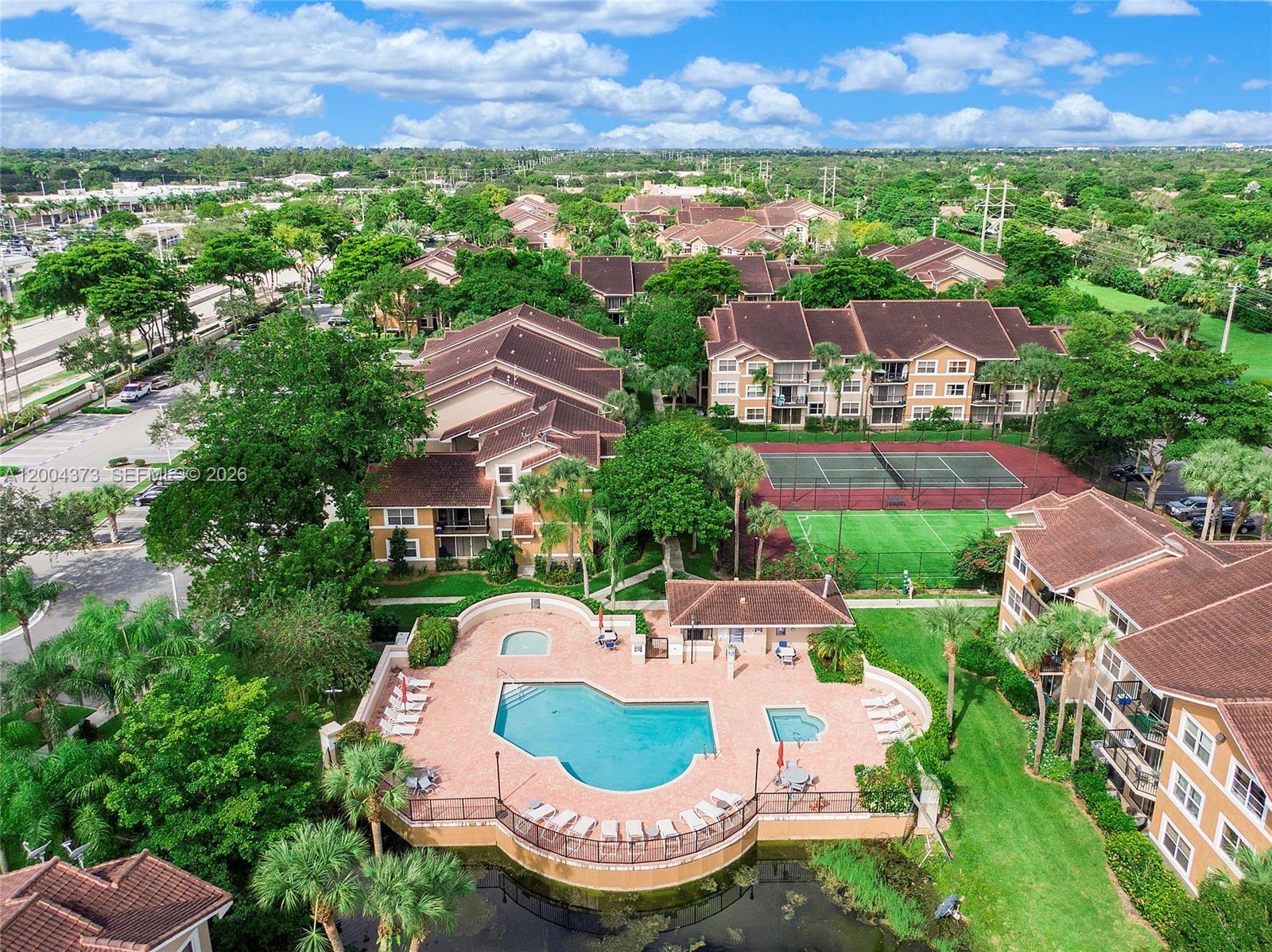 8761 Wiles Road, Unit 306 Coral Springs, FL 33067 - Photo 10 of 19 an aerial view of a house with garden space and outdoor seating