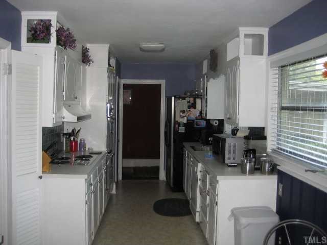 809 Graham Street Raleigh, NC 27605 - Photo 2 of 10 a kitchen with refrigerator and cabinets