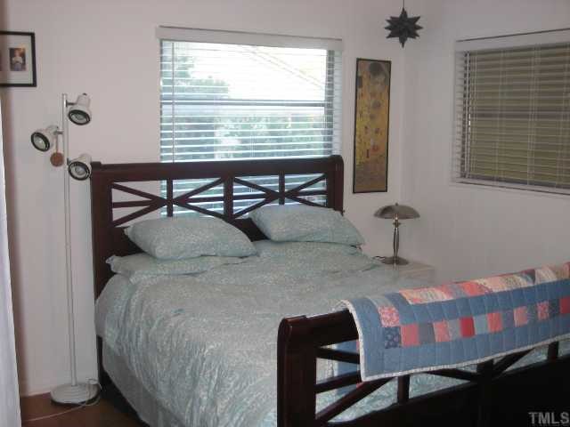 809 Graham Street Raleigh, NC 27605 - Photo 5 of 10 a bedroom with a bed a table and chair