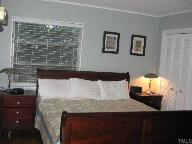 809 Graham Street Raleigh, NC 27605 - Photo 6 of 10 a bedroom with a bed and a lamp