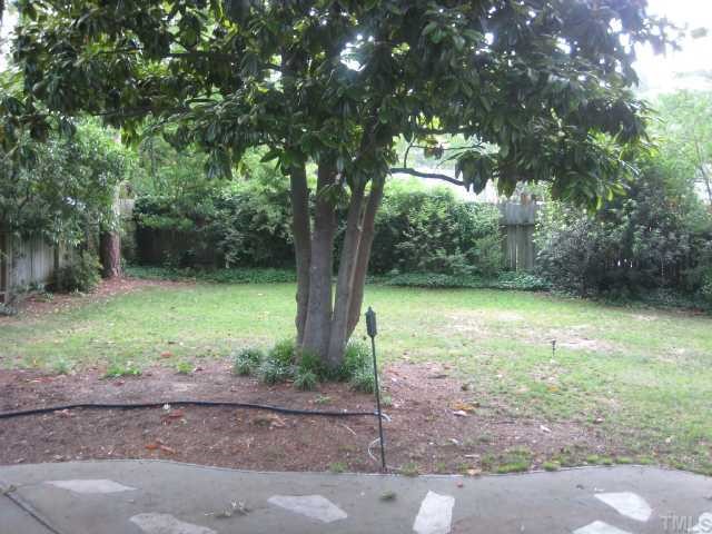 809 Graham Street Raleigh, NC 27605 - Photo 10 of 10 a backyard of a house with lots of plants and large trees