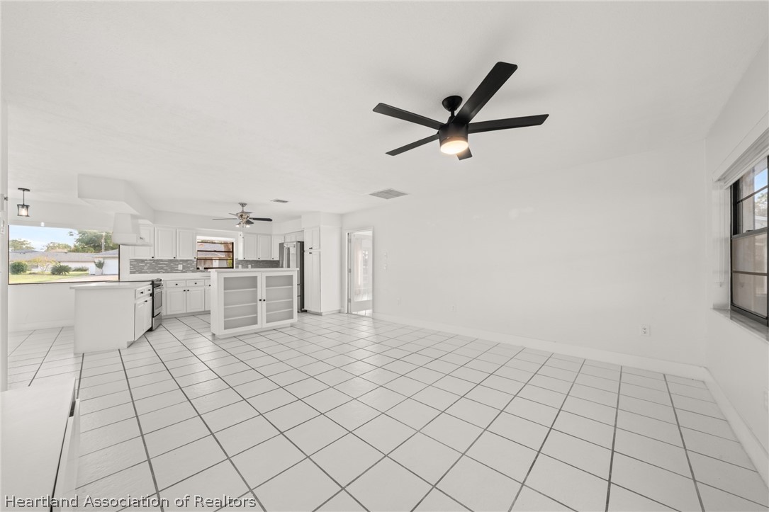 3407 Divot Road Sebring, FL 33872 - Photo 9 of 39 a view of kitchen with cabinets and window