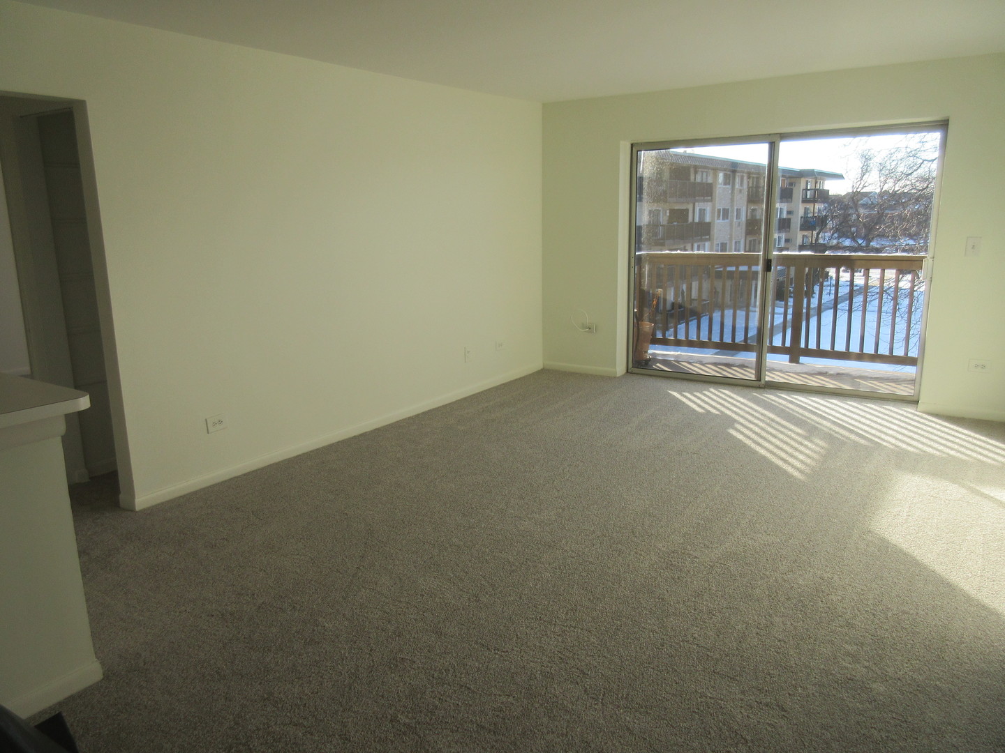 2214 South Goebbert Road, Unit 382 Arlington Heights, IL 60005 - Photo 5 of 9 a view of a room with wooden floor and a window