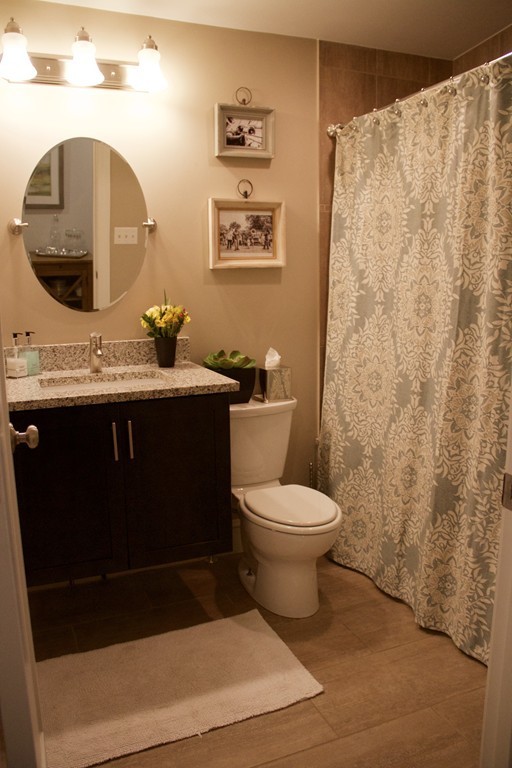 47 Soley Street, Unit 2 Boston, MA 02129 - Photo 12 of 23 a bathroom with a toilet a sink and mirror
