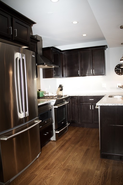 47 Soley Street, Unit 2 Boston, MA 02129 - Photo 4 of 23 a kitchen with stainless steel appliances a stove a refrigerator and a sink