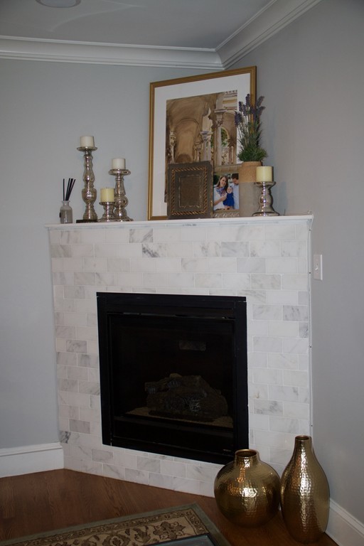 47 Soley Street, Unit 2 Boston, MA 02129 - Photo 9 of 23 a fireplace with a clock on top of it
