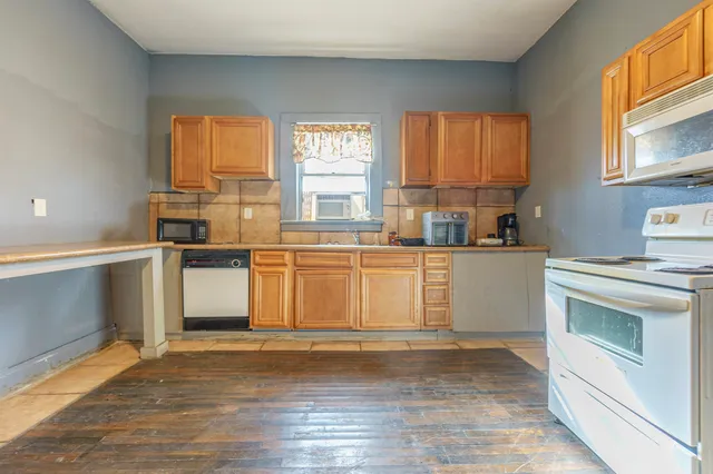 a kitchen with stainless steel appliances a stove top oven and a sink