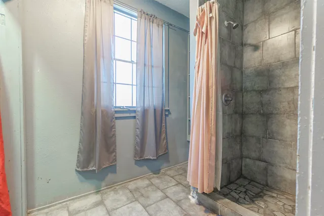 a bathroom with a glass door shower