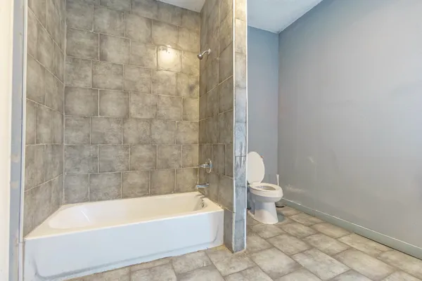 a bathroom with a bathtub and a toilet