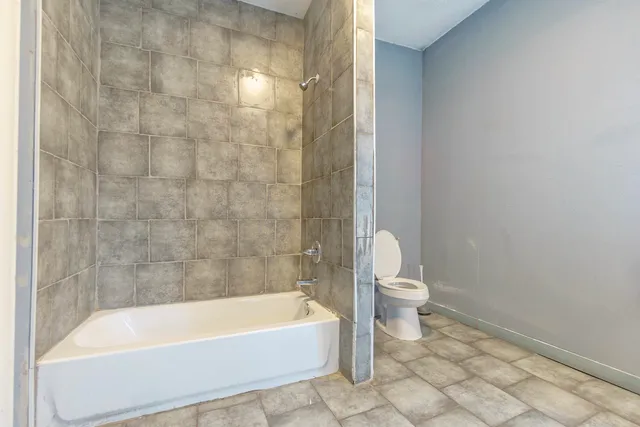 a bathroom with a bathtub and a toilet