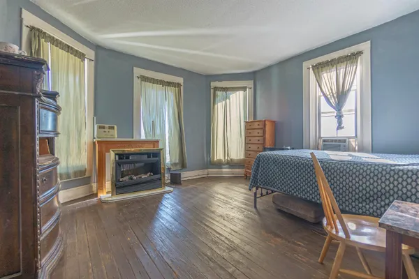 a spacious bedroom with a bed and a fireplace
