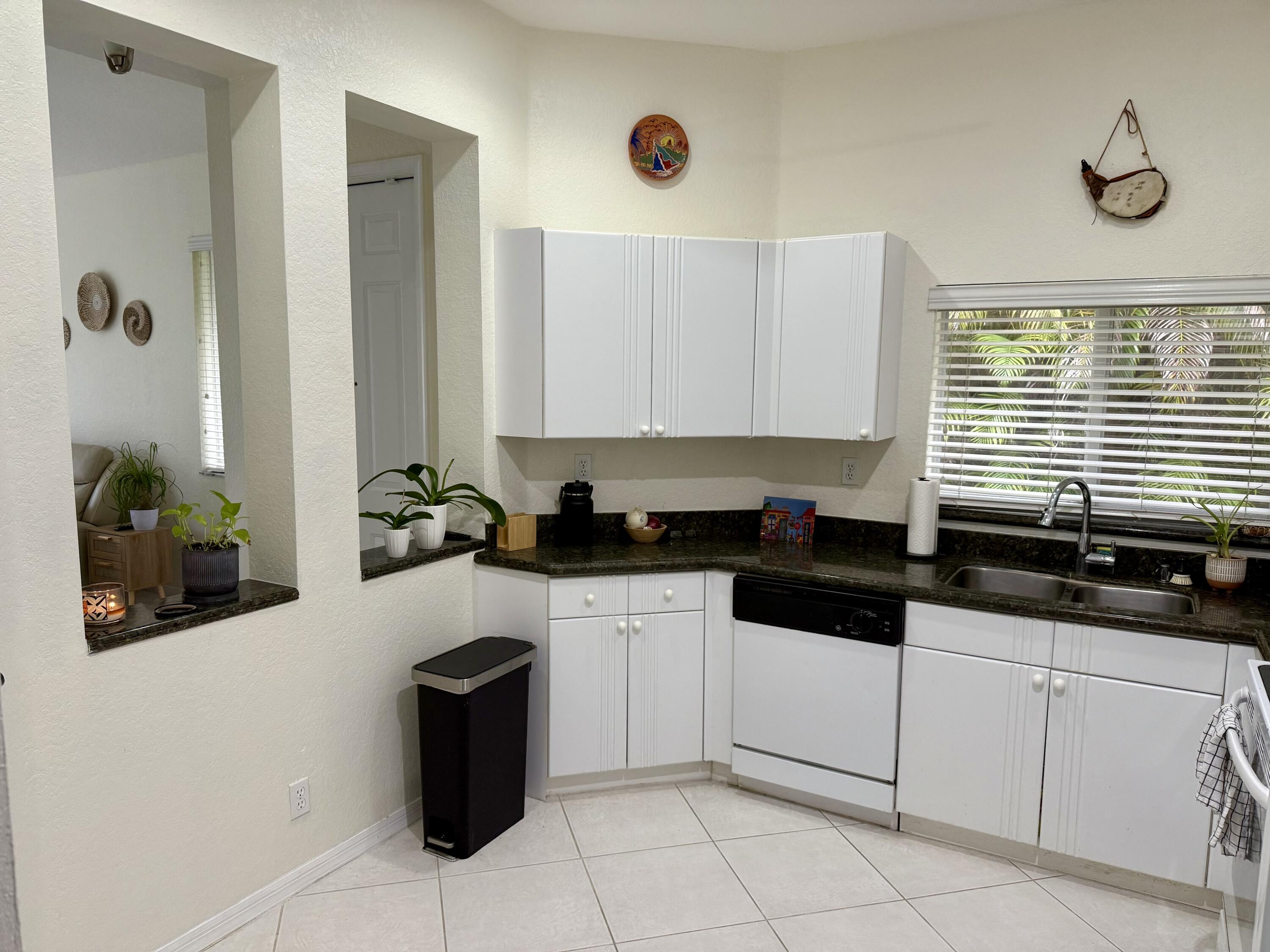 15864 Southwest 10th Street Pembroke Pines, FL 33027 - Photo 2 of 11 a kitchen with granite countertop a sink a stove and cabinets
