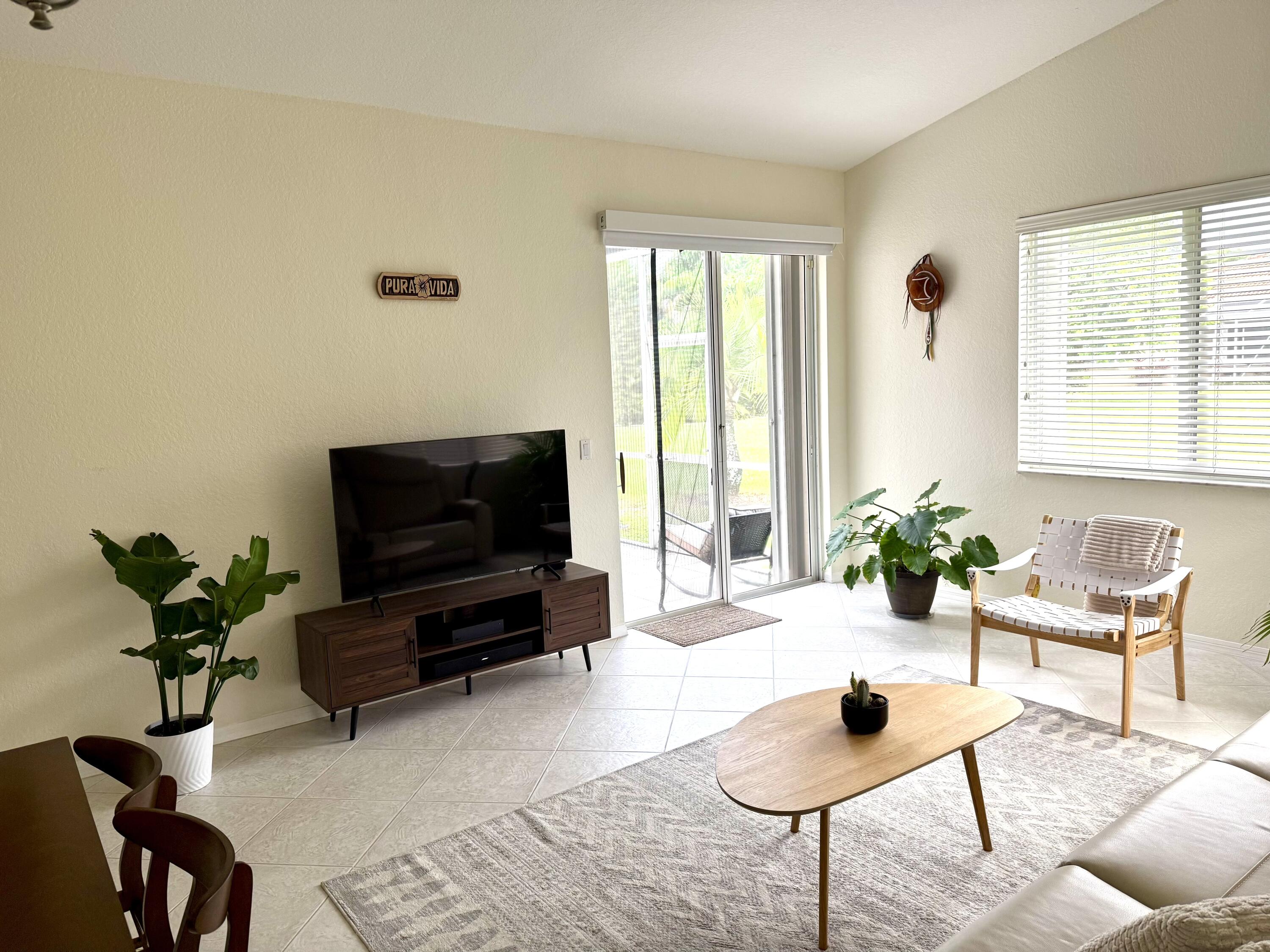 15864 Southwest 10th Street Pembroke Pines, FL 33027 - Photo 7 of 11 a living room with furniture and a flat screen tv