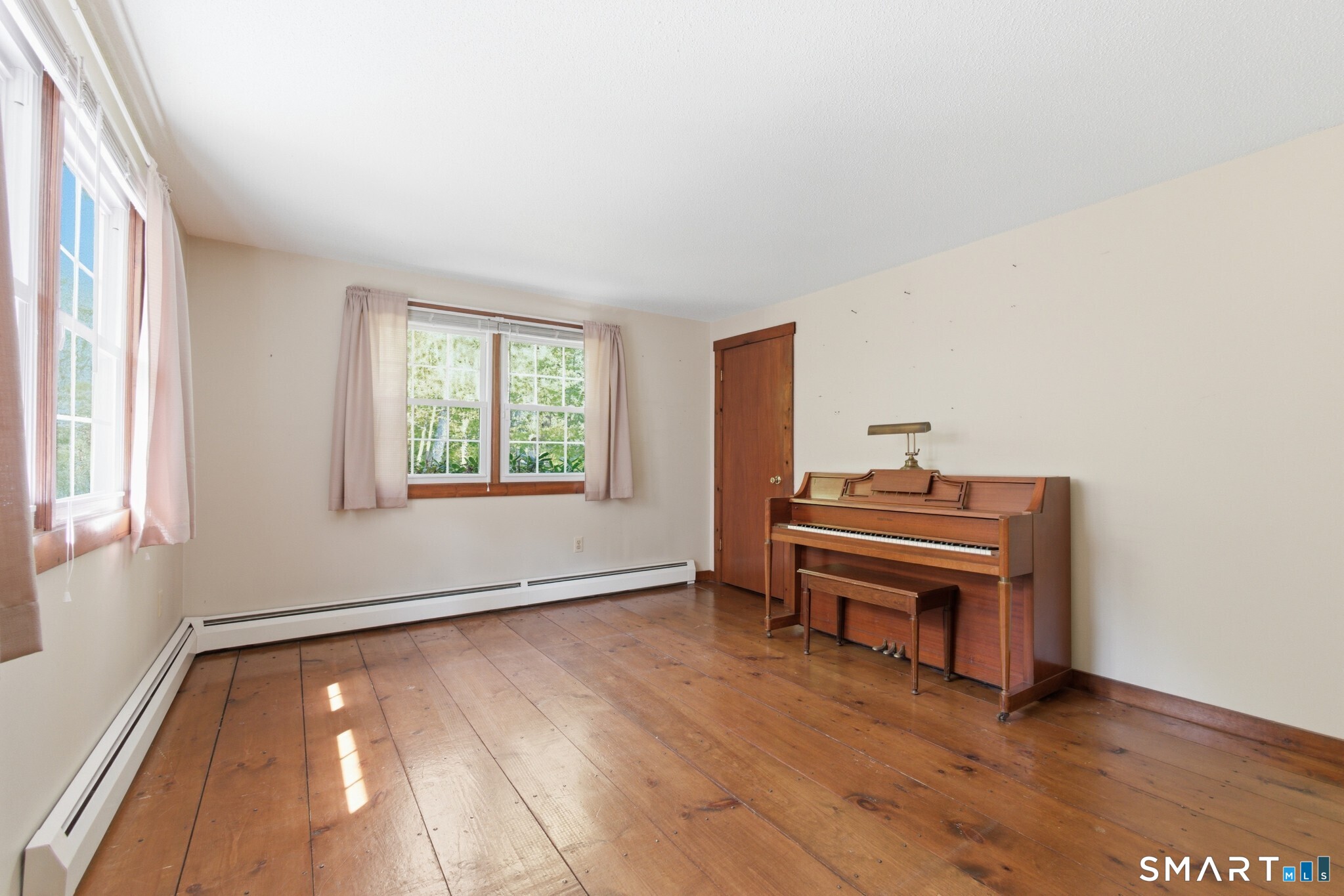 70 Mahoney Road Colchester, CT 06415 - Photo 14 of 40 an empty room with windows and wooden floor