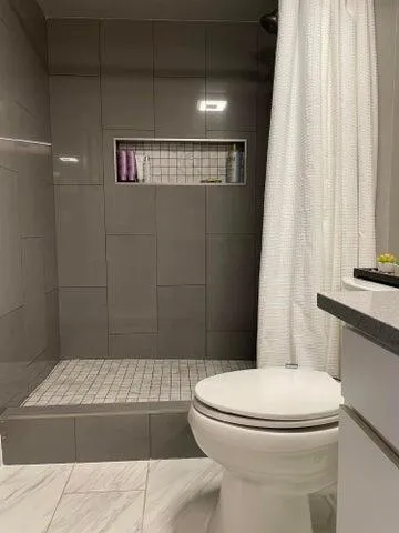 a view of bathroom with a toilet sink and mirror
