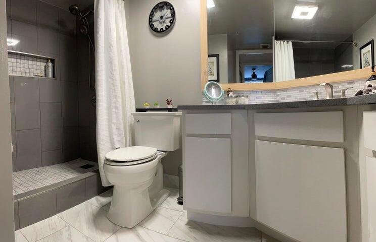 1200 Scotia Drive, Unit 305 Hypoluxo, FL 33462 - Photo 12 of 28 a view of bathroom with a toilet sink and mirror